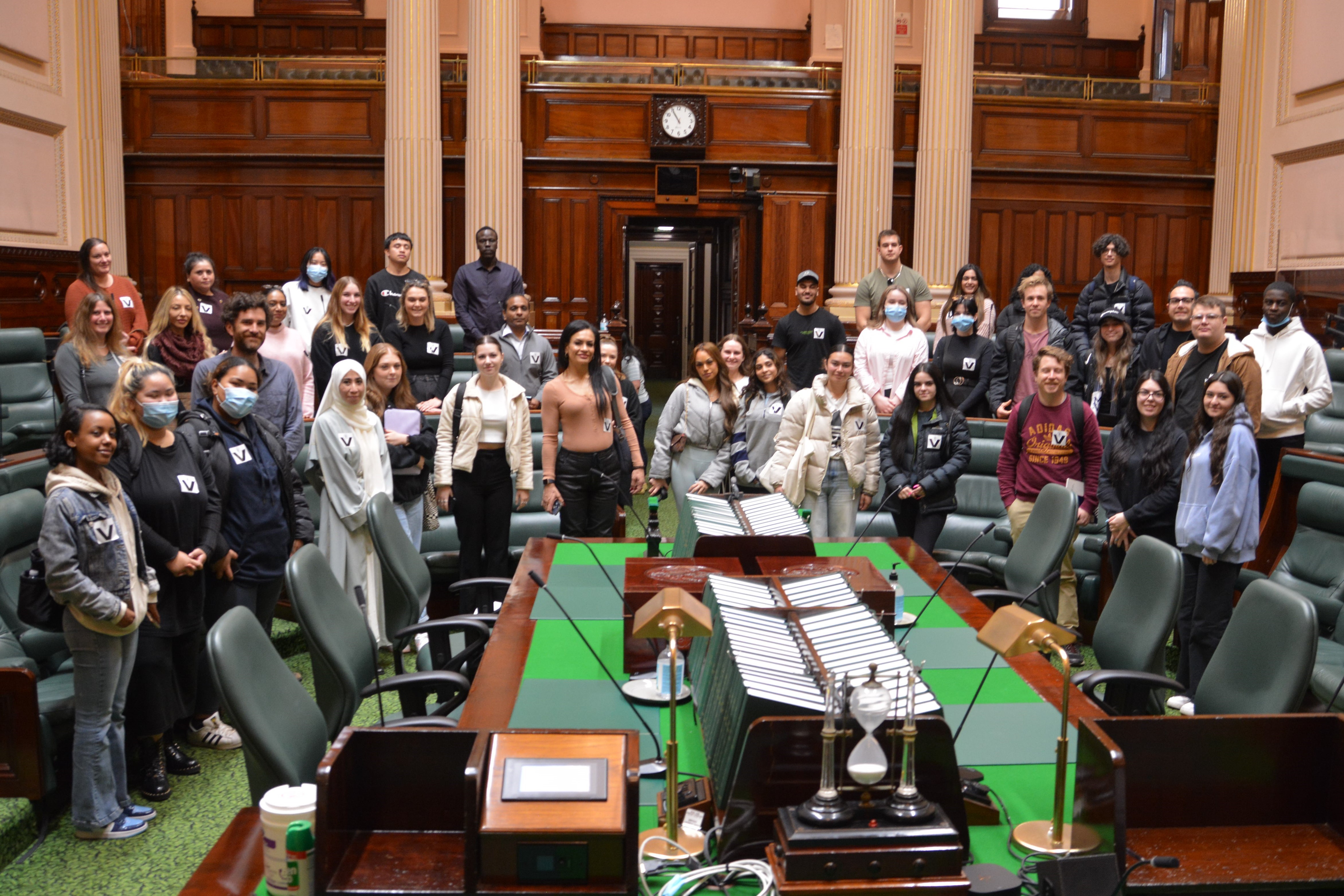Victoria University students learning in the Legislative Assembly chamber.