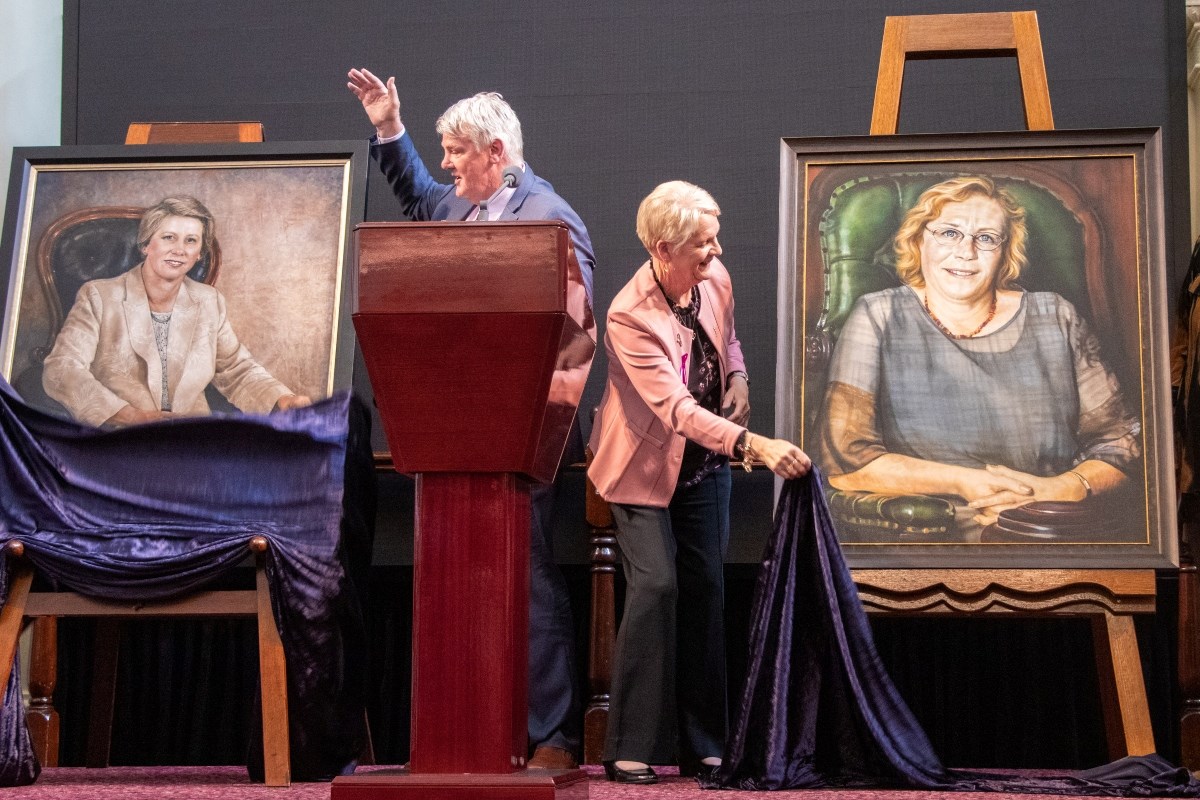 Presiding Officers Shaun Leane and Maree Edwards unveiling portraits of Monica Gould and Judy Maddigan.