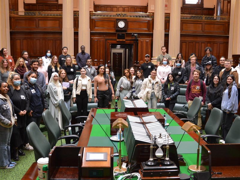 Victoria University students learning in the Legislative Assembly chamber.