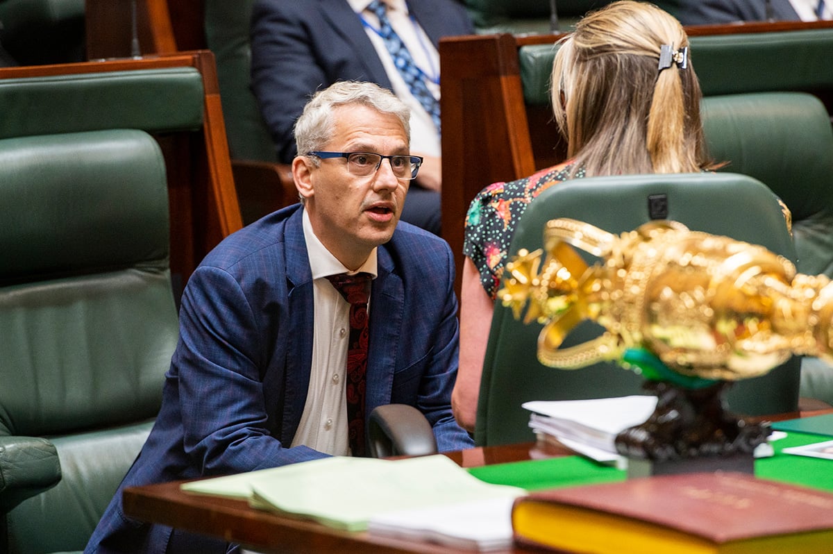 Members talk in the Legislative Assembly chamber.