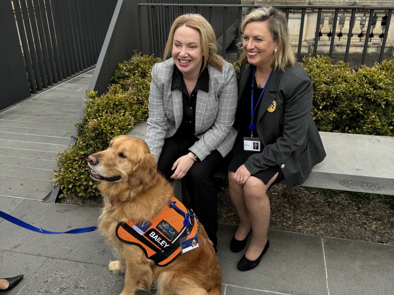 Pakenham MP Emma Vulin and Cranbourne MP Pauline Richards with therapy dog Bailey at Parliament House.
