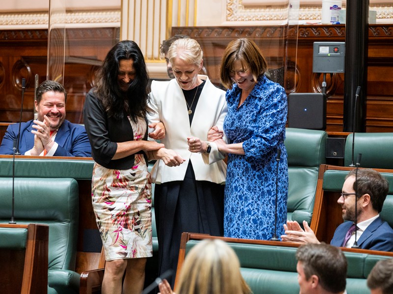 As is tradition, newly re-elected Assembly Speaker Maree Edwards is escorted to the chamber chair by her supporters.